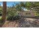Side view of house shows mature trees and simple siding at 3395 Hardee Dr, Venice, FL 34292