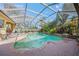 Inviting pool and spa area, fully screened, and surrounded by lush landscaping at 4850 Sweetshade Dr, Sarasota, FL 34241