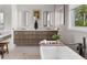 Bathroom featuring a freestanding tub, dual vanities, modern lighting, and large window with views of the surrounding landscape at 6821 Longboat S Dr, Longboat Key, FL 34228