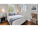 Comfortable bedroom with hardwood floors, natural light, and neutral decor for a serene and inviting space at 6821 Longboat S Dr, Longboat Key, FL 34228