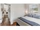 Cozy bedroom with hardwood floors, a comfortable bed, and a window providing natural light at 6821 Longboat S Dr, Longboat Key, FL 34228