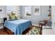 Bright bedroom features hardwood floors, natural light, and a cozy decor at 6821 Longboat S Dr, Longboat Key, FL 34228