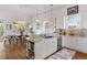 Bright kitchen with white cabinets, modern appliances, and an island with a sink and dishwasher at 6821 Longboat S Dr, Longboat Key, FL 34228