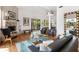 Bright living room features a fireplace, hardwood floors, and large glass doors to the outdoor living at 6821 Longboat S Dr, Longboat Key, FL 34228