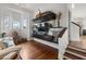 Stylish living room with modern built-ins, hardwood floors, and large windows providing natural light at 6821 Longboat S Dr, Longboat Key, FL 34228