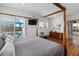 Spacious main bedroom with four-poster bed, balcony access, and lots of natural light from sliding glass doors at 6821 Longboat S Dr, Longboat Key, FL 34228