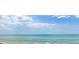 Beautiful ocean view featuring calm, turquoise water under a blue sky with scattered clouds at 7314 Point Of Rocks Rd, Sarasota, FL 34242