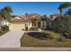 Charming one-story home featuring a two-car garage, tile roof, and lush landscaping at 7902 Haven Harbour Way, Bradenton, FL 34212