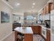 Spacious kitchen boasting an island with wood cabinetry and modern appliances with a view to the living room at 7902 Haven Harbour Way, Bradenton, FL 34212