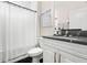 Clean bathroom with dark-veined vanity, a subway tiled shower, and a clean toilet with white floor at 1012 Fernleaf Run, Bradenton, FL 34212