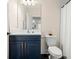 This bathroom includes a white vanity with dark countertops and navy blue cabinets, plus subway tile shower at 1012 Fernleaf Run, Bradenton, FL 34212