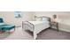 Cozy bedroom featuring a black metal bed frame, side tables, and a turquoise cushioned bench at 1012 Fernleaf Run, Bradenton, FL 34212