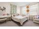 Bedroom with a white bed, a gold bed frame, neutral colors, and natural lighting through decorative curtains at 1012 Fernleaf Run, Bradenton, FL 34212