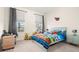 Bright bedroom featuring a bed with colorful linens, fun decorations, and carpeted floors at 1012 Fernleaf Run, Bradenton, FL 34212