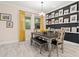 Dining room featuring a wooden table, natural light, and decoratively displayed artwork at 1012 Fernleaf Run, Bradenton, FL 34212