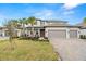 Beautiful two-story home with well-maintained landscaping, a three-car garage, and a welcoming entrance at 1012 Fernleaf Run, Bradenton, FL 34212