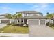 Elegant two-story home with a three-car garage, beautifully landscaped yard, and charming curb appeal at 1012 Fernleaf Run, Bradenton, FL 34212