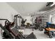 Bright garage transformed into a fully equipped gym with modern fitness machines and durable flooring at 1012 Fernleaf Run, Bradenton, FL 34212