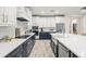 A stunning kitchen features white cabinets, stainless steel appliances and a spacious island at 1012 Fernleaf Run, Bradenton, FL 34212