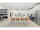 A kitchen boasts a large island with seating, white cabinets, and stainless steel appliances at 1012 Fernleaf Run, Bradenton, FL 34212
