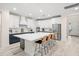 A modern kitchen featuring a spacious island with bar stools and stainless steel appliances at 1012 Fernleaf Run, Bradenton, FL 34212