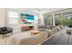 A bright living room features a large sectional sofa, modern furniture and sliding glass doors at 1012 Fernleaf Run, Bradenton, FL 34212