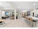 Open-concept living space with dining area, modern furnishings, and large windows for natural light at 1012 Fernleaf Run, Bradenton, FL 34212