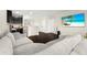 Cozy living room with a large sectional sofa, television, and dark wood flooring at 1012 Fernleaf Run, Bradenton, FL 34212
