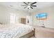 Spacious main bedroom featuring a large bed, flatscreen tv, and open doorway to en-suite bathroom at 1012 Fernleaf Run, Bradenton, FL 34212