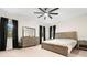 Comfortable bedroom featuring a wooden bed frame, matching dresser, and black curtains at 1012 Fernleaf Run, Bradenton, FL 34212