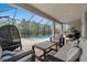 Screened-in outdoor lounge with comfortable seating, perfect for enjoying the poolside view and fresh air at 1012 Fernleaf Run, Bradenton, FL 34212