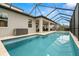 Inviting screened-in pool area featuring travertine tile, blue tile trim, and ample space for outdoor entertaining at 1012 Fernleaf Run, Bradenton, FL 34212