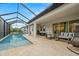 Screened-in outdoor pool with modern furniture creating an inviting space for relaxation and entertainment at 1012 Fernleaf Run, Bradenton, FL 34212