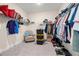 Spacious walk-in closet with shelving for clothing, shoe racks, and carpeted floors at 1012 Fernleaf Run, Bradenton, FL 34212