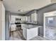 Well-lit kitchen with white cabinetry, stainless steel appliances, and tile backsplash at 2203 18Th Street E Ct, Bradenton, FL 34208