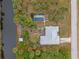 Overhead view of property with pool, lush landscaping, and proximity to a waterway at 230 Salisbury St, Port Charlotte, FL 33954