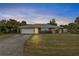 Charming single-story home featuring a well-maintained lawn and attached two-car garage at 230 Salisbury St, Port Charlotte, FL 33954