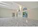 Bright living room boasts high ceilings, chandelier lighting, and marble floors with large glass doors at 26071 Paysandu Dr, Punta Gorda, FL 33983