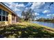The backyard has a lush lawn, a waterfront view, and a view of the screened-in porch at 3716 Eagle Hammock Dr, Sarasota, FL 34240