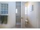 Bright bathroom featuring tiled walk-in shower, glass block window, and a toilet at 3716 Eagle Hammock Dr, Sarasota, FL 34240