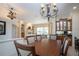 Formal dining room with wood table and chairs, elegant lighting, and an open floor plan at 3716 Eagle Hammock Dr, Sarasota, FL 34240