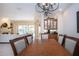 Formal dining room with wood table and chairs, elegant lighting, and an open floor plan at 3716 Eagle Hammock Dr, Sarasota, FL 34240