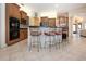 Spacious kitchen with breakfast bar, wood cabinetry, modern appliances, and tile flooring at 3716 Eagle Hammock Dr, Sarasota, FL 34240