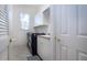 Bright laundry room with white cabinets, modern appliances, and plenty of storage at 3716 Eagle Hammock Dr, Sarasota, FL 34240