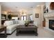 Cozy living room featuring a fireplace, comfortable seating, and a view to the dining area at 3716 Eagle Hammock Dr, Sarasota, FL 34240