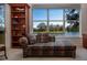 Comfortable office space with large window and water view, featuring a cushioned chaise lounge at 3716 Eagle Hammock Dr, Sarasota, FL 34240