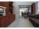 Comfortable home office featuring custom cabinets, desk, and view of the lanai and pool at 3716 Eagle Hammock Dr, Sarasota, FL 34240