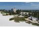 Breathtaking aerial view of the beachfront property, showcasing pristine sands and stunning waterfront residences at 4350 Chatham Dr # 208, Longboat Key, FL 34228