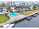 An aerial view showcases the pool, boat docks, and waterfront access of this condo community at 4350 Chatham Dr # 208, Longboat Key, FL 34228