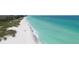 Expansive aerial view of the shoreline featuring crystal-clear turquoise water and a pristine sandy beach at 4350 Chatham Dr # 208, Longboat Key, FL 34228